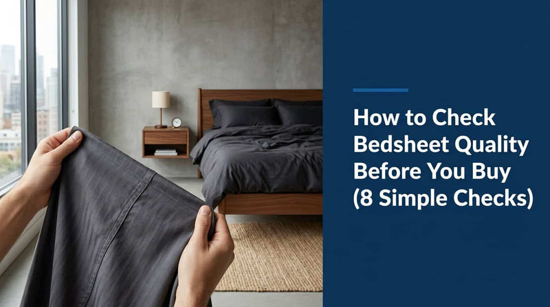 Hand feeling the fabric of a dark grey bedsheet to check its quality