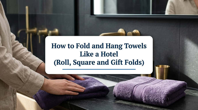 Hands folding a purple towel next to neatly folded towels