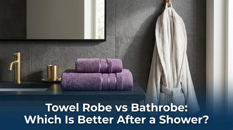 Purple towels folded beside a white bathrobe hanging in a bathroom