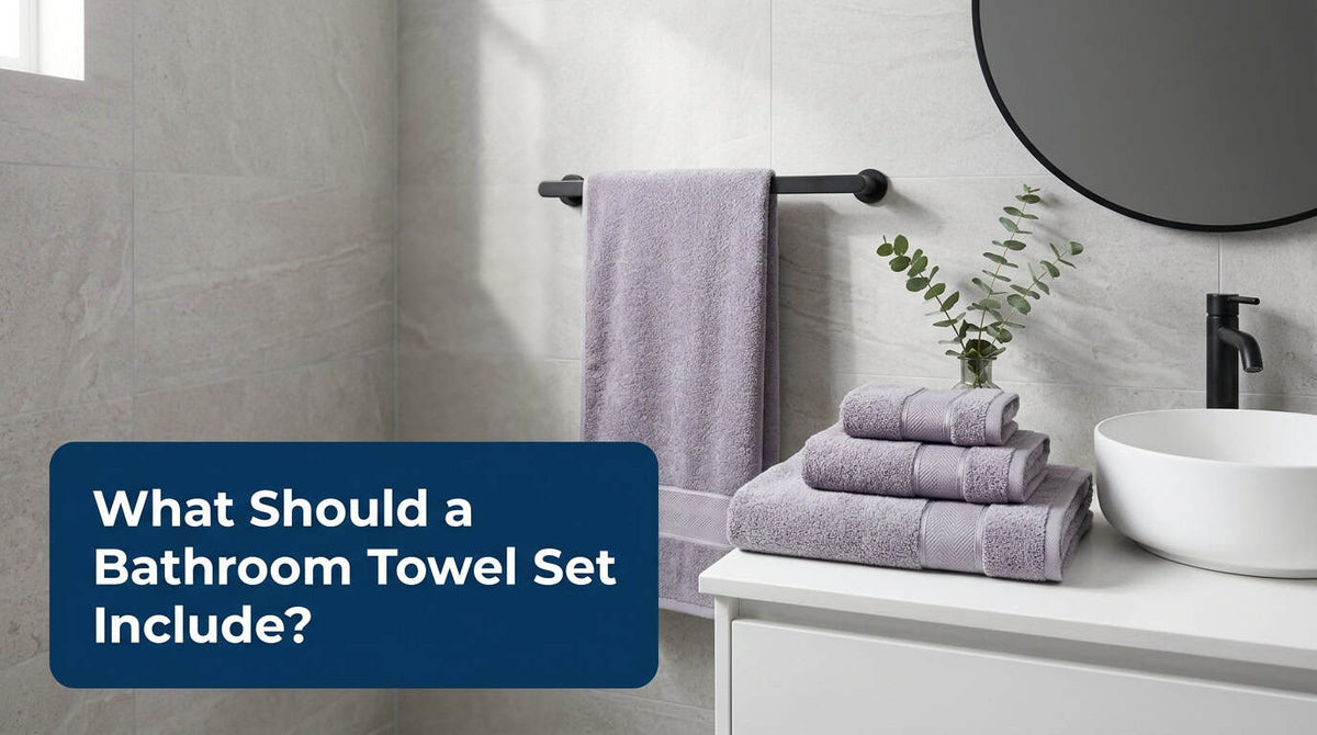 Lavender grey bathroom towel set hanging and stacked by the basin