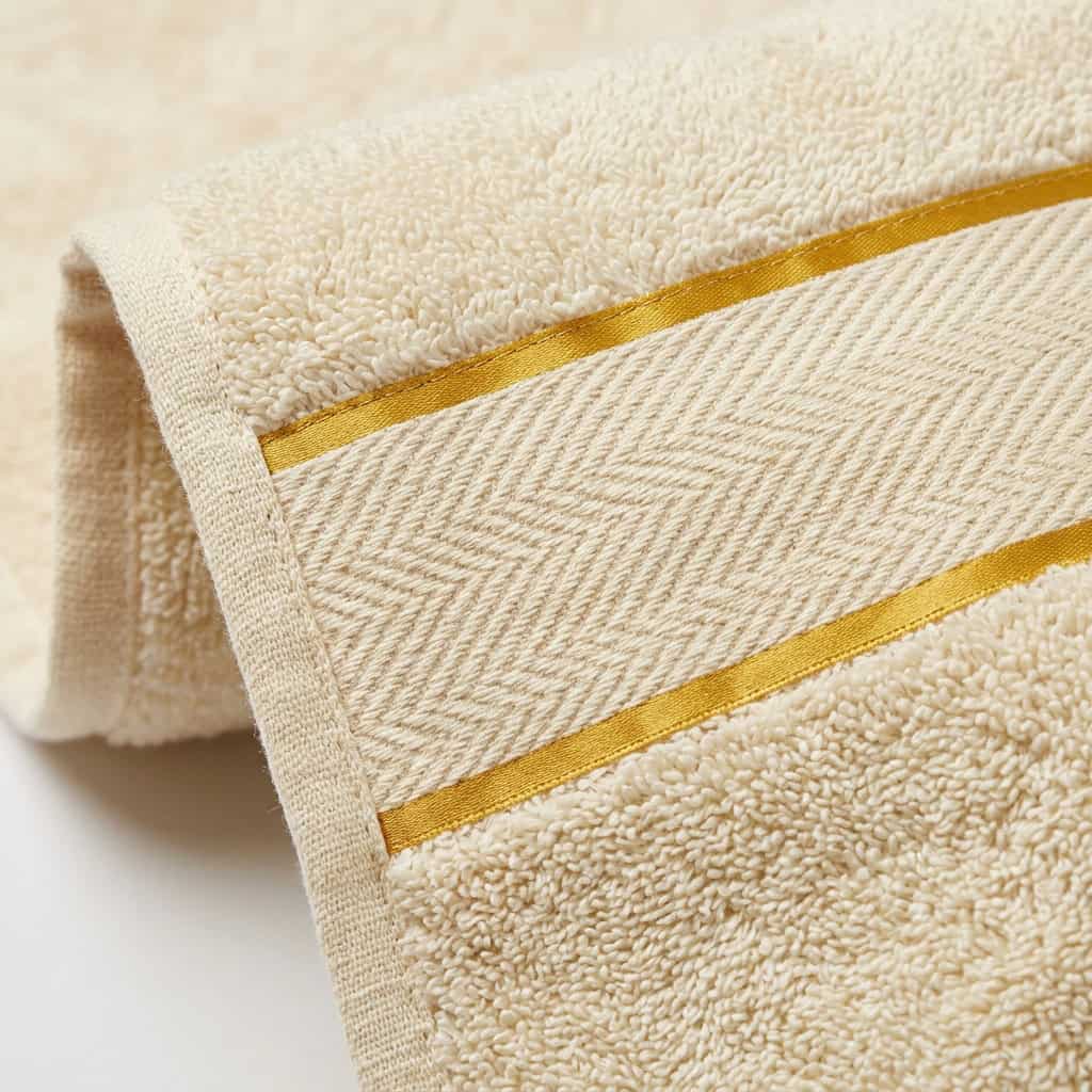 Close-up of cream cotton towel loops and woven border