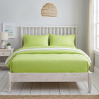 Lime green cotton fitted bedsheet with 2 pillow covers on a king size bed