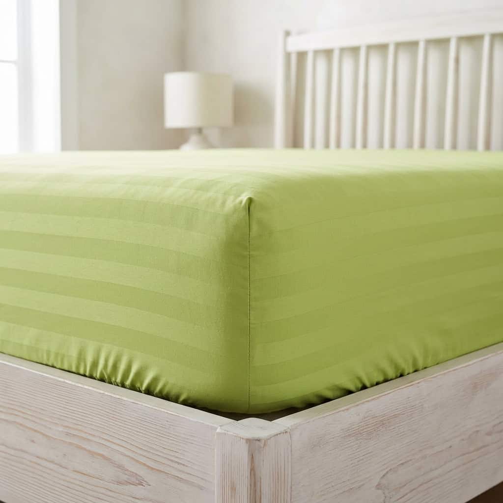 Lime green fitted sheet with elastic sides around a mattress corner