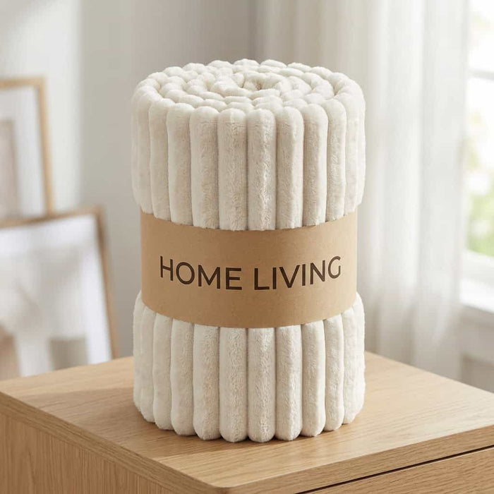 Rolled off-white ribbed fleece AC blanket with a Home Living label