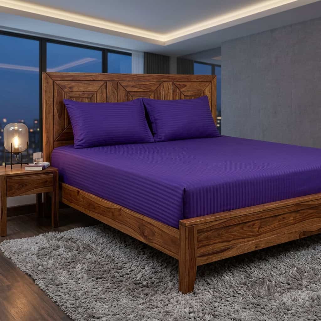 Royal purple king size fitted bedsheet set on a bed, angled view