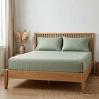 Sage green cotton fitted bedsheet with 2 pillow covers on a king size bed