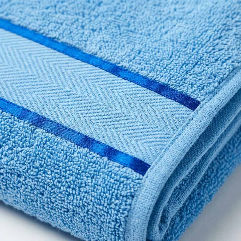 Close-up of sky blue cotton towel loops and woven border