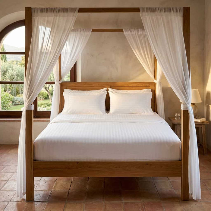 White cotton fitted bedsheet with 2 pillow covers on a king size bed